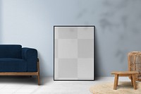 Picture frame png mockup leaning on a blue wall in a living room