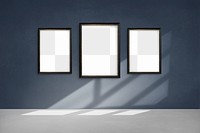 Black picture frame mockups hanging on  a blue wall