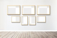 Wooden picture frame mockups hanging on a gray wall