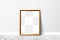 Wooden picture frame mockup leaning against a gray wall
