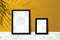 Black picture frame mockups against a yellow wall