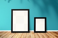 Black picture frame mockups against a blue wall
