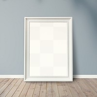 White picture frame mockup leaning against a gray wall