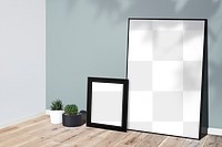 Picture frame mockups leaning against a gray wall on a wooden floor