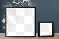Black picture frame mockups leaning against a gray wall