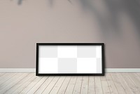 Black picture frame mockup against a brown wall