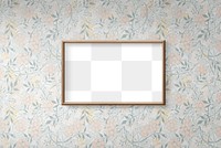 Blank wooden picture frame mockup hanging on a floral wallpapered wall