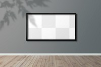 Black picture frame mockup hanging on a gray wall