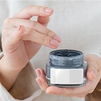 Woman holding a face cream jar design element