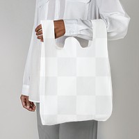 Black woman carrying a white reusable grocery bag mockup 