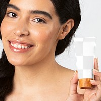 Cheerful woman holding a cream tube container mockup 