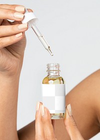 Woman using a bottle dropper mockup