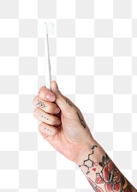 Tattooed hand holding a toothbrush transparent png