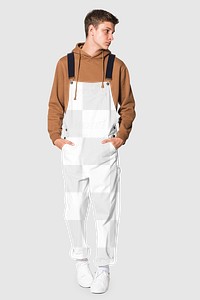 Png transparent dungarees mockup with brown hoodie for street style shoot