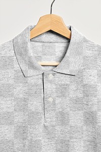 Gray men's collared shirt on a wooden hanger 