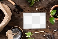 Png paper mockup on wooden table with plants flat lay