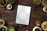 Tablet png screen mockup on plant parent table flat lay