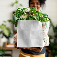 Png shopping bag mockup with plant inside eco-friendly shop