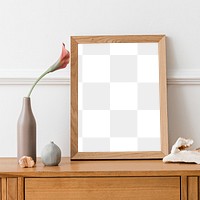 Picture frame mockup on a wooden sideboard table with a flower in a vase 