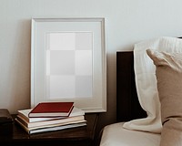 White picture frame png mockup on bedside table