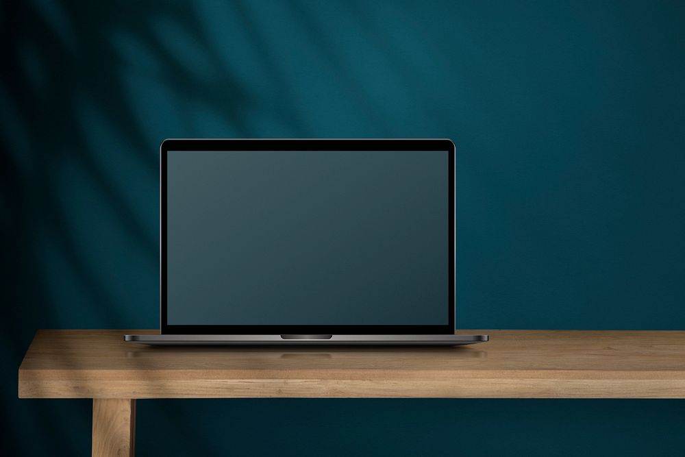 Laptop mockup, blue wall workspace