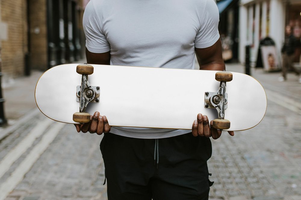 Man holding skateboard mockup, editable design