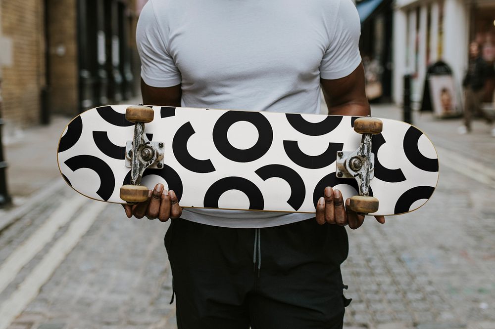 Man holding skateboard mockup, editable design