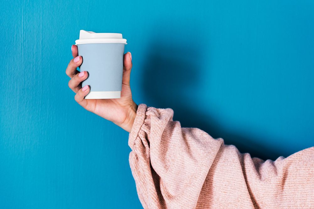 Holding disposable cup mockup, editable design