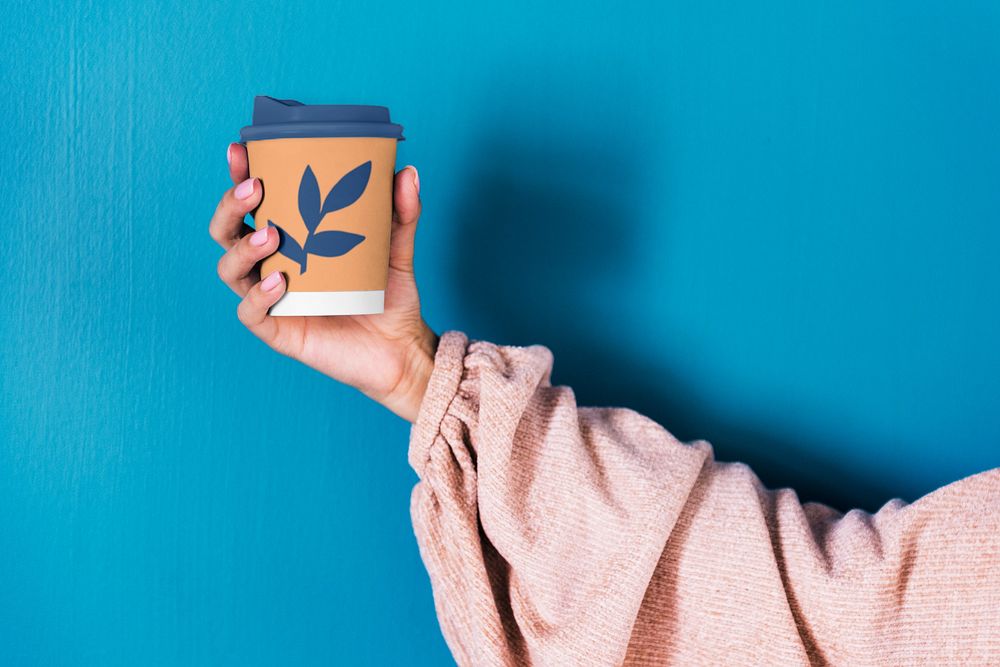 Holding disposable cup mockup, editable design