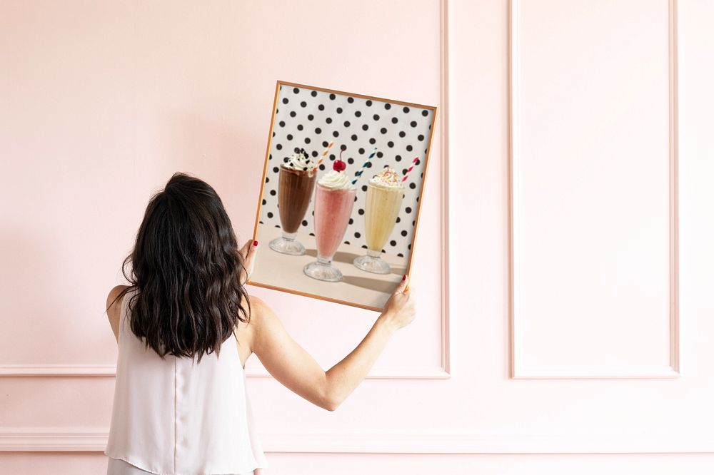 Photo frame mockup, woman decorating wall