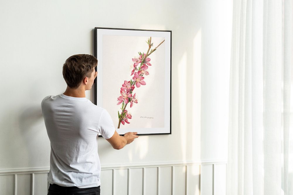 Photo frame mockup, man decorating wall