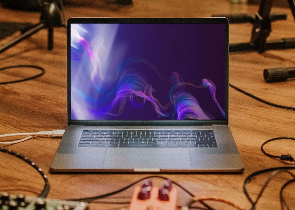 Laptop mockup in music studio, customizable notebook screen