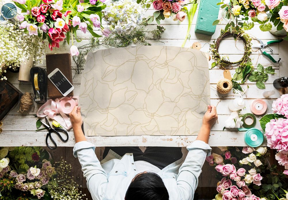 Editable paper mockup laid out by a person in a florist 