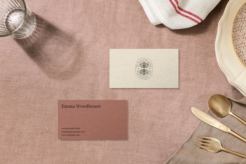 Editable business card mockup on a dining table