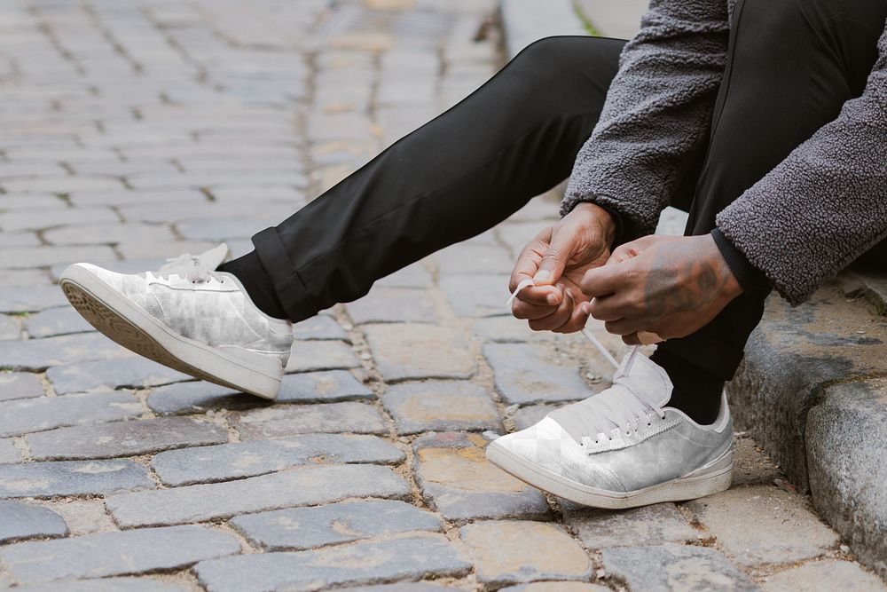 Sneaker shoe png mockups, transparent design, man tying shoelaces on the street