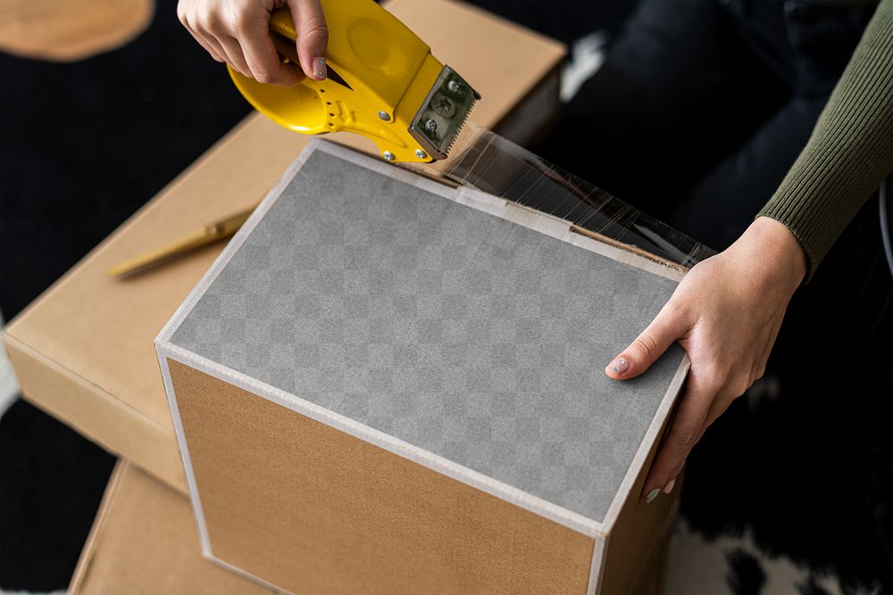 Parcel box transparent mockup png being packed for delivery by a small business owner