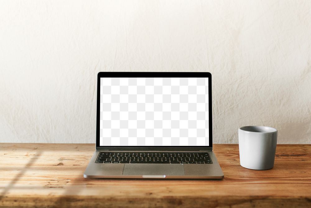 Laptop png mockup with coffee mug on wooden table