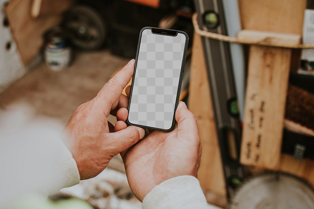 Man holding png smartphone mockup near a construction site