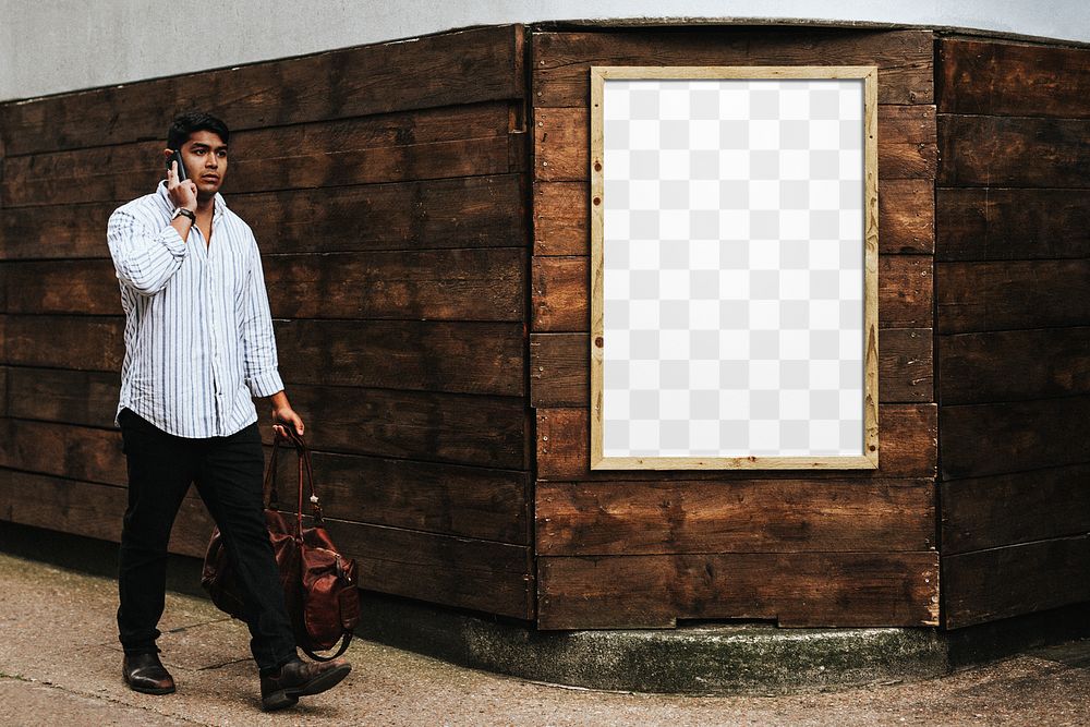 Wooden frame png mockup psd on a brick wall with a man passing by