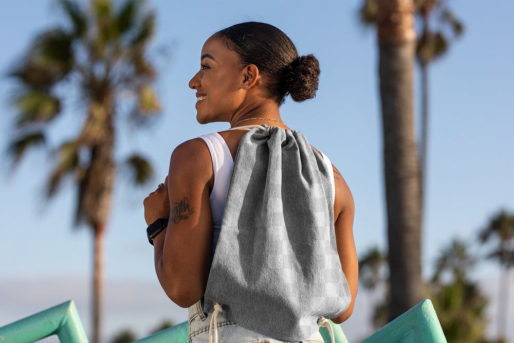 Drawstring bag png mockup, African American woman at the beach