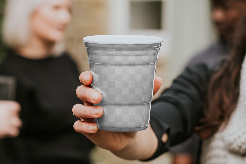 Plastic cup png mockup being held by a man 