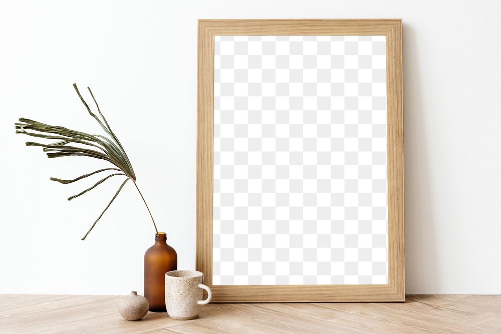 Picture frame mockup on a wooden sideboard table with a dried leaf in a bottle vase