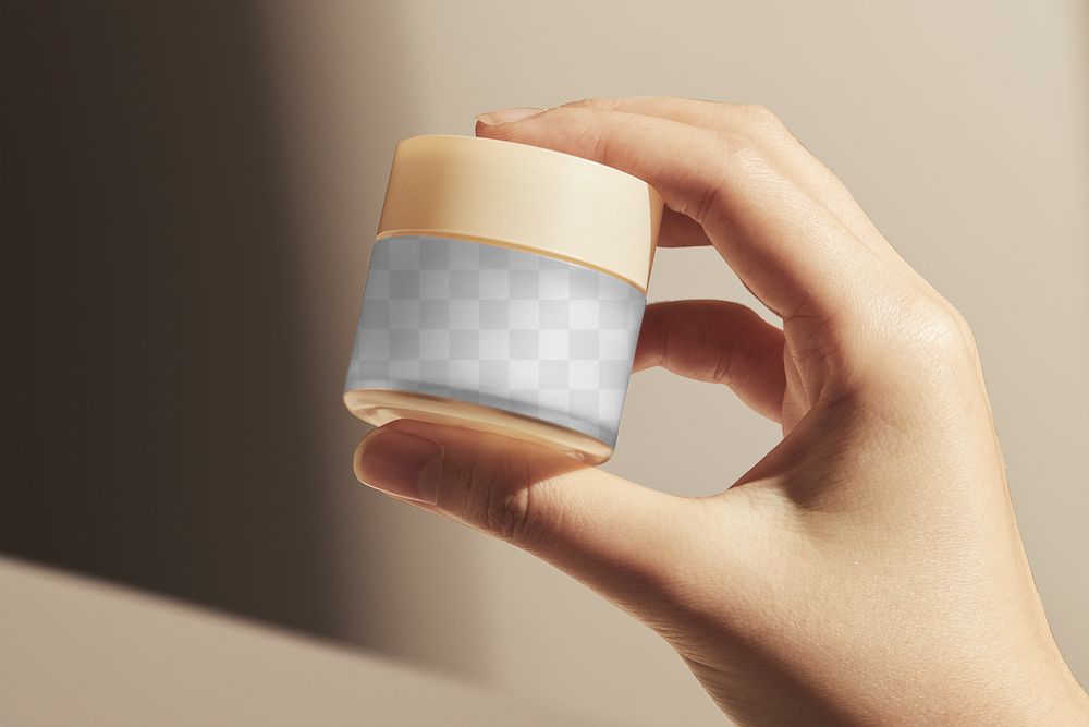 Cosmetic jar png mockup transparent, held by hand in natural light