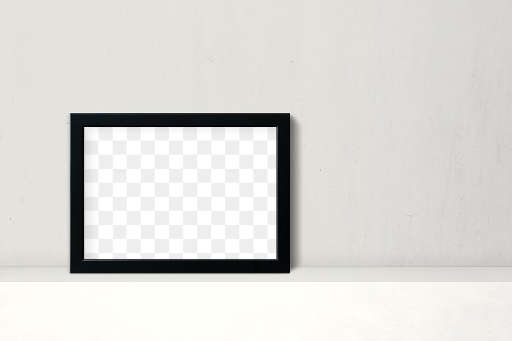 Black picture frame mockup leaning against a white wall