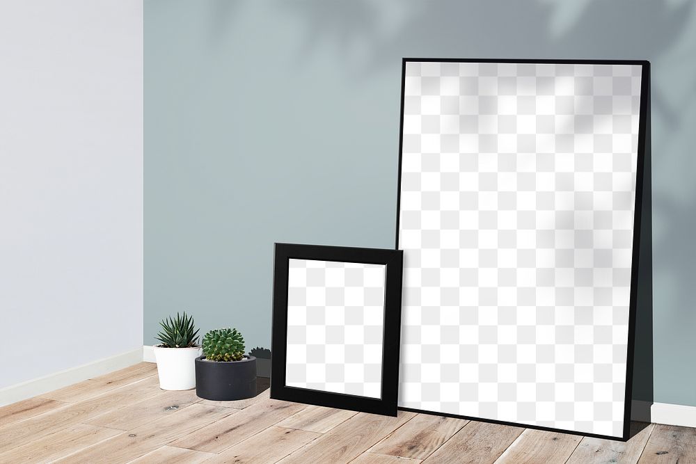 Picture frame mockups leaning against a gray wall on a wooden floor