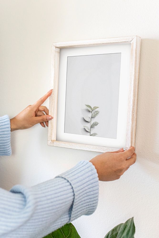 Photo frame mockup, woman decorating wall