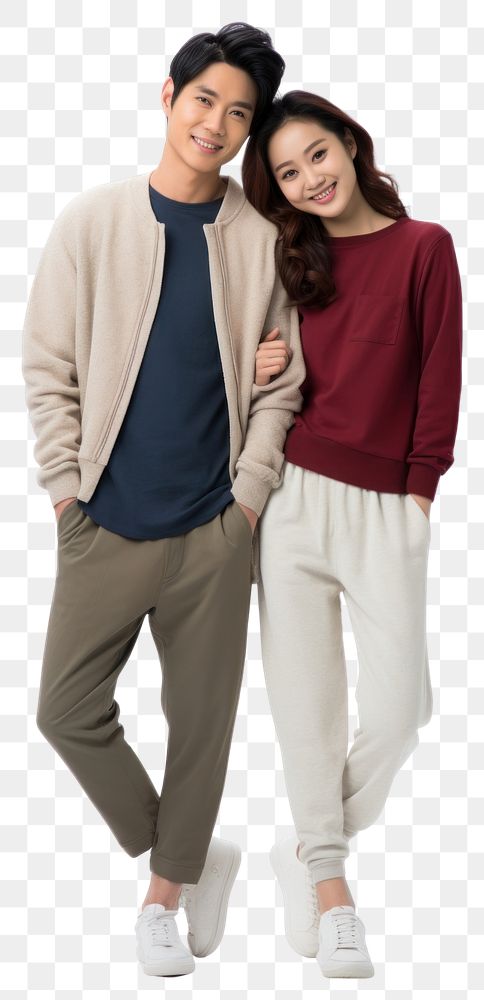 PNG A young asian couple hugging and looking at the camera standing sweater sleeve. AI generated Image by rawpixel.