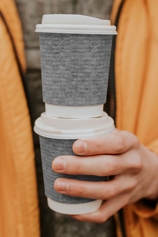 Png coffee cup mockup with hand holding closeup