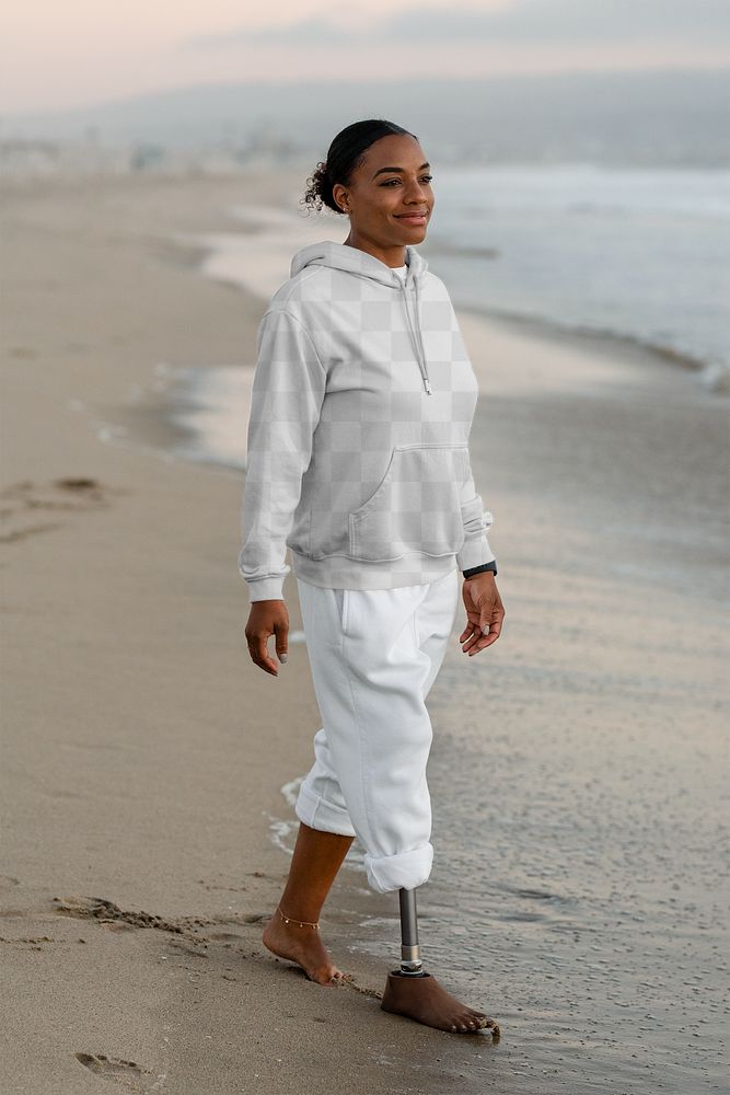 Hoodie mockup png, amputee woman walking by the beach 