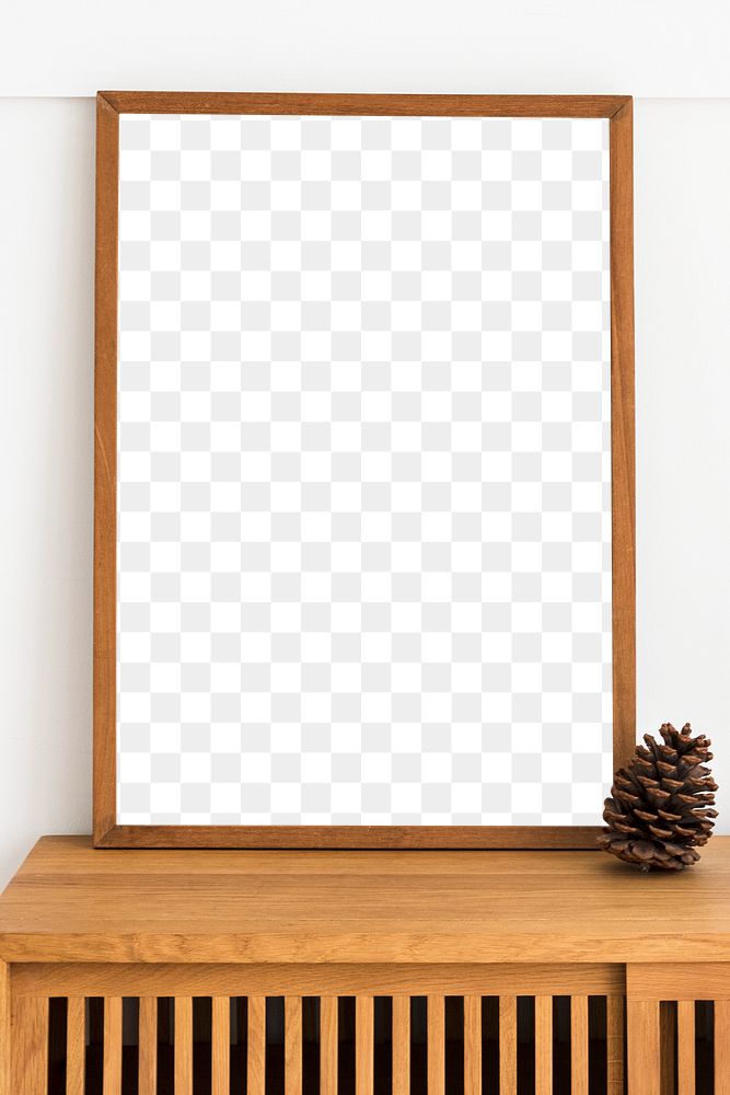 Picture frame mockup on a wooden sideboard table with a pine cone 